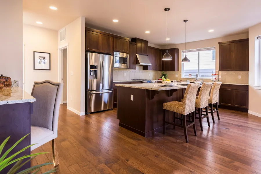 Hand-scraped hickory floor in a kitchen with a dark island